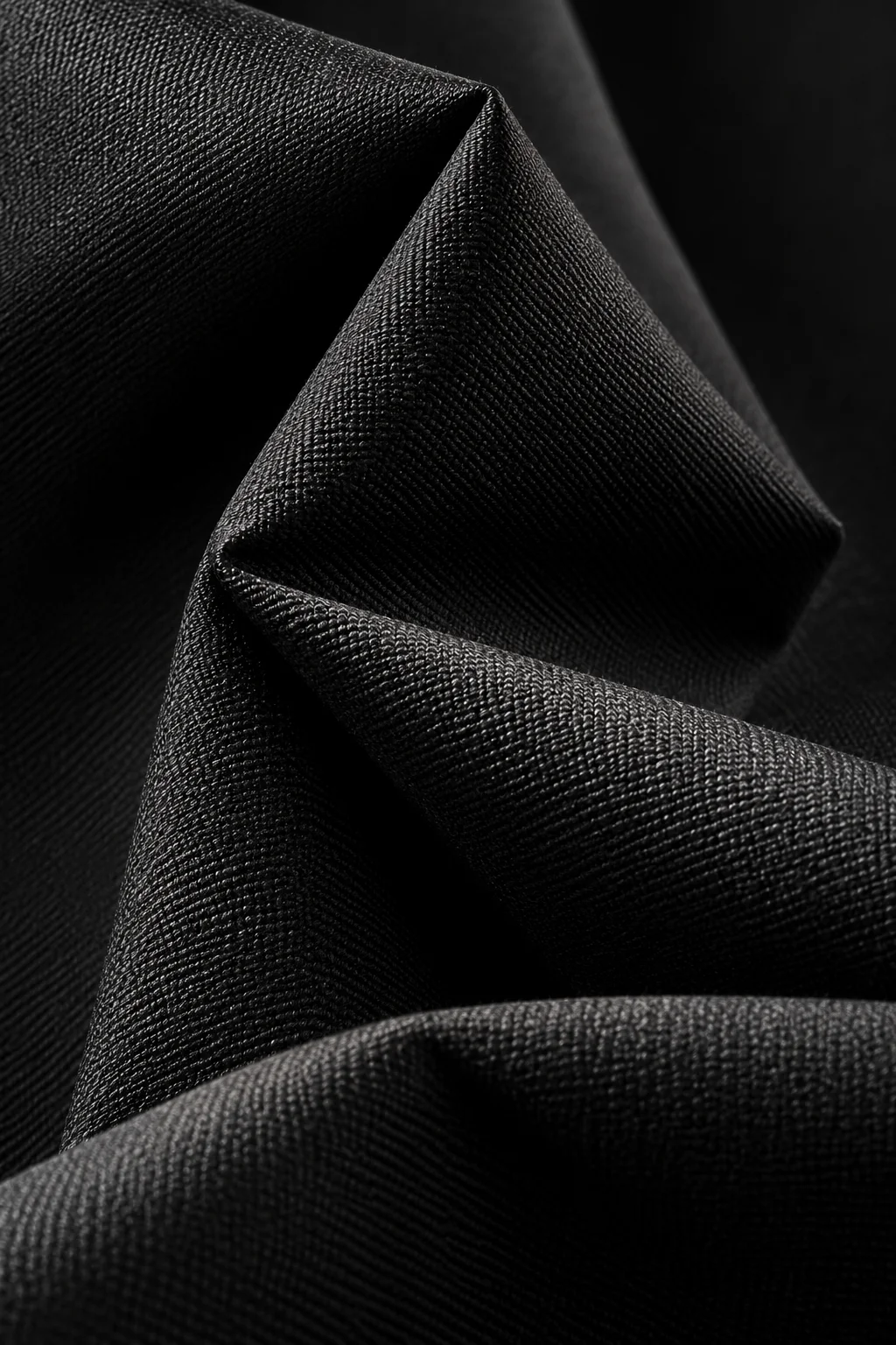 Detail of the weave and sculptural folds in black tailoring fabric